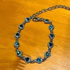 Blue heart bracelet with silver tone chain.